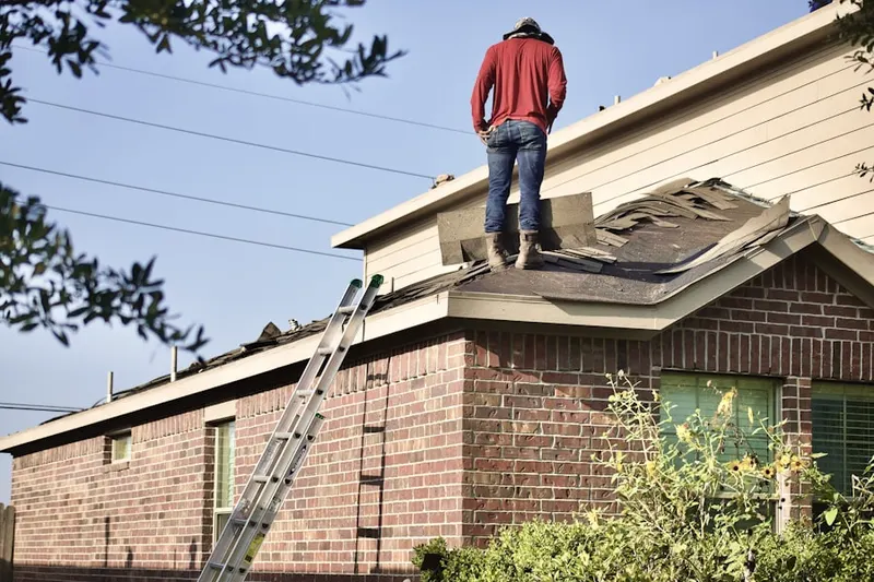 Professional roofer working on a residential roof in Forest Manor North